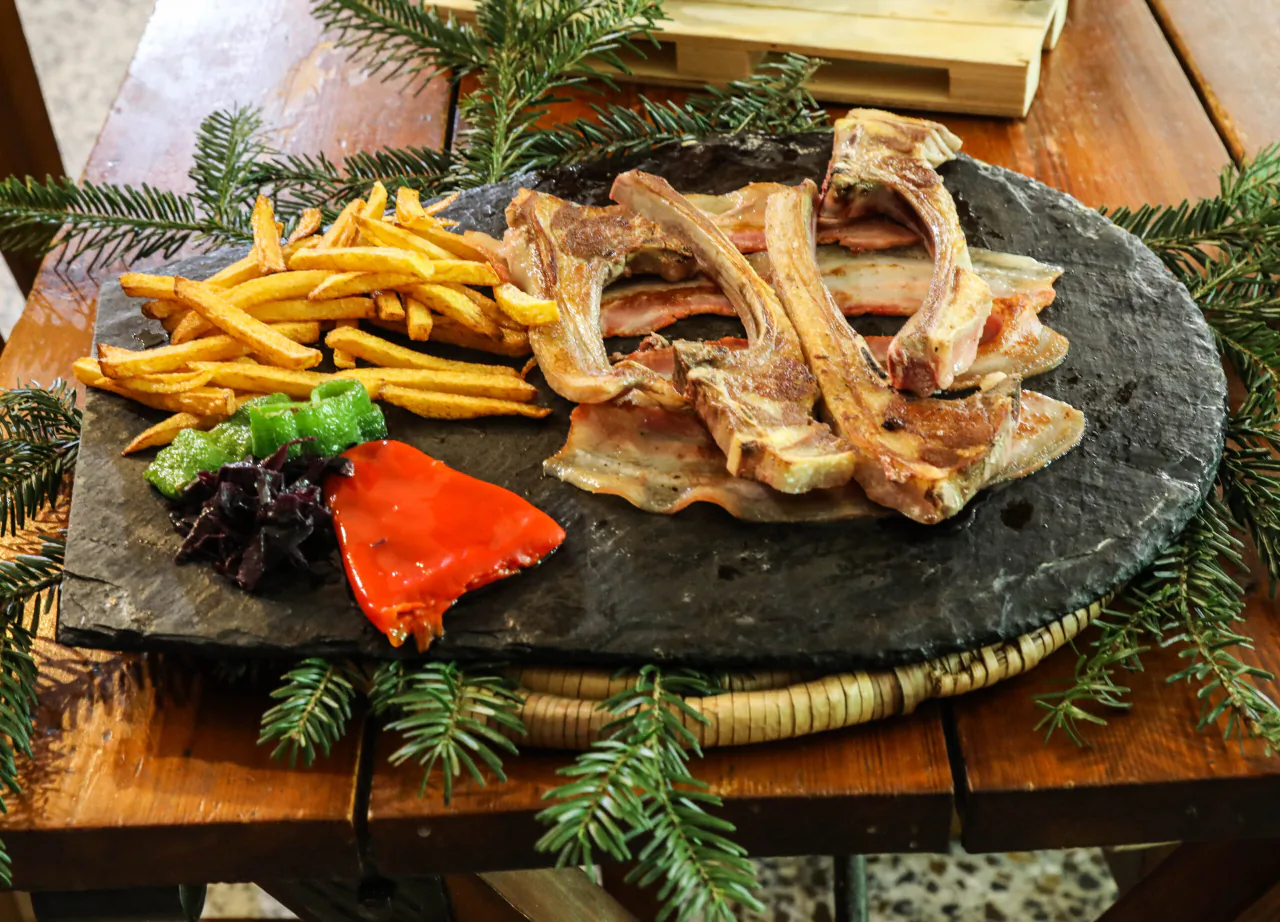 Lamb chops on the stone with potatoes and vegetables