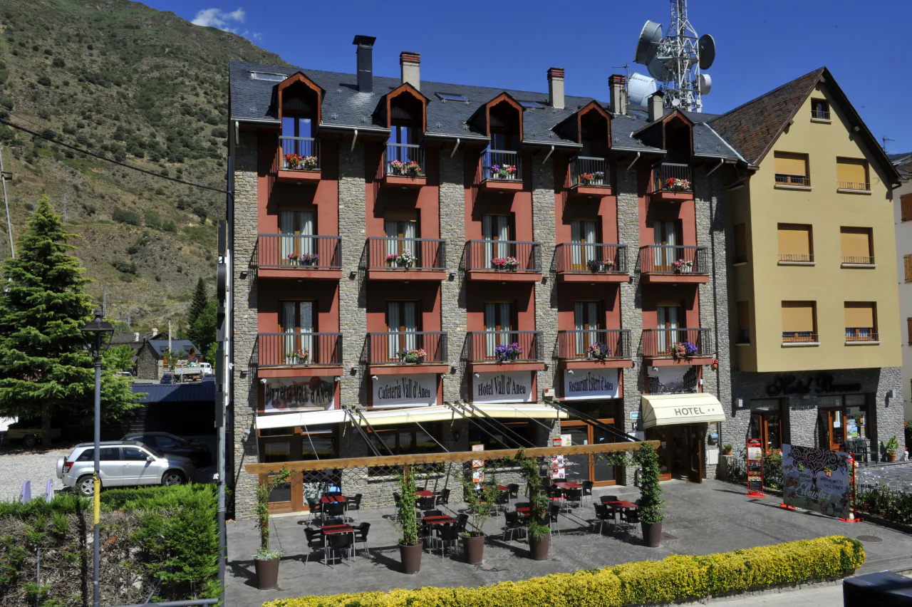 The hotel's facade on carrer Major, with its red balconies